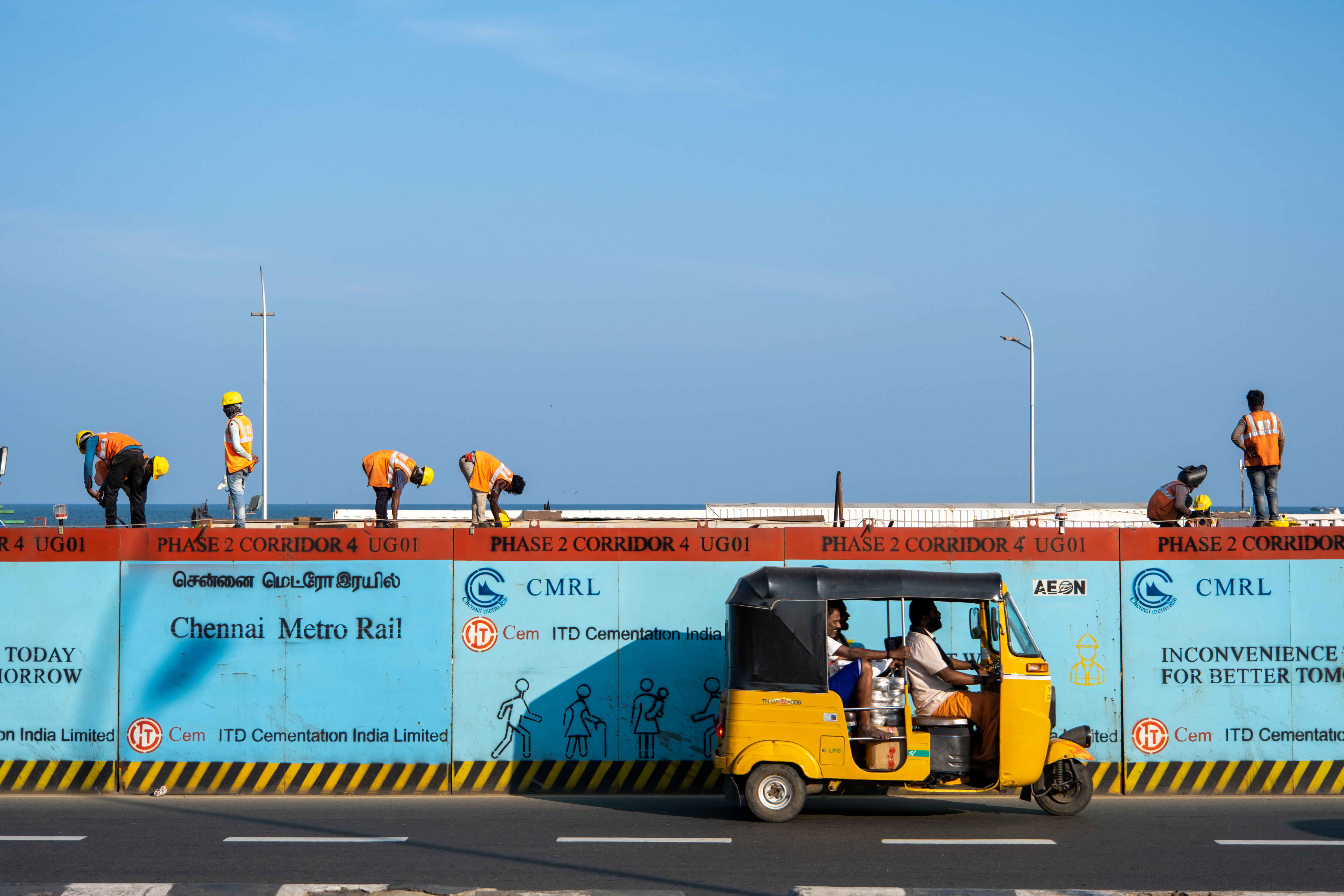 rickshaw riding in front of construction